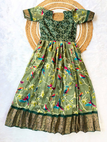 Stunning olive green long frock featuring a delicate bird design