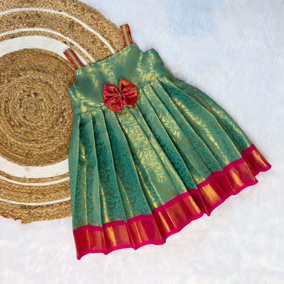 Celebrate this festive season with our Premium Green with Pink Kanchipattu Frock