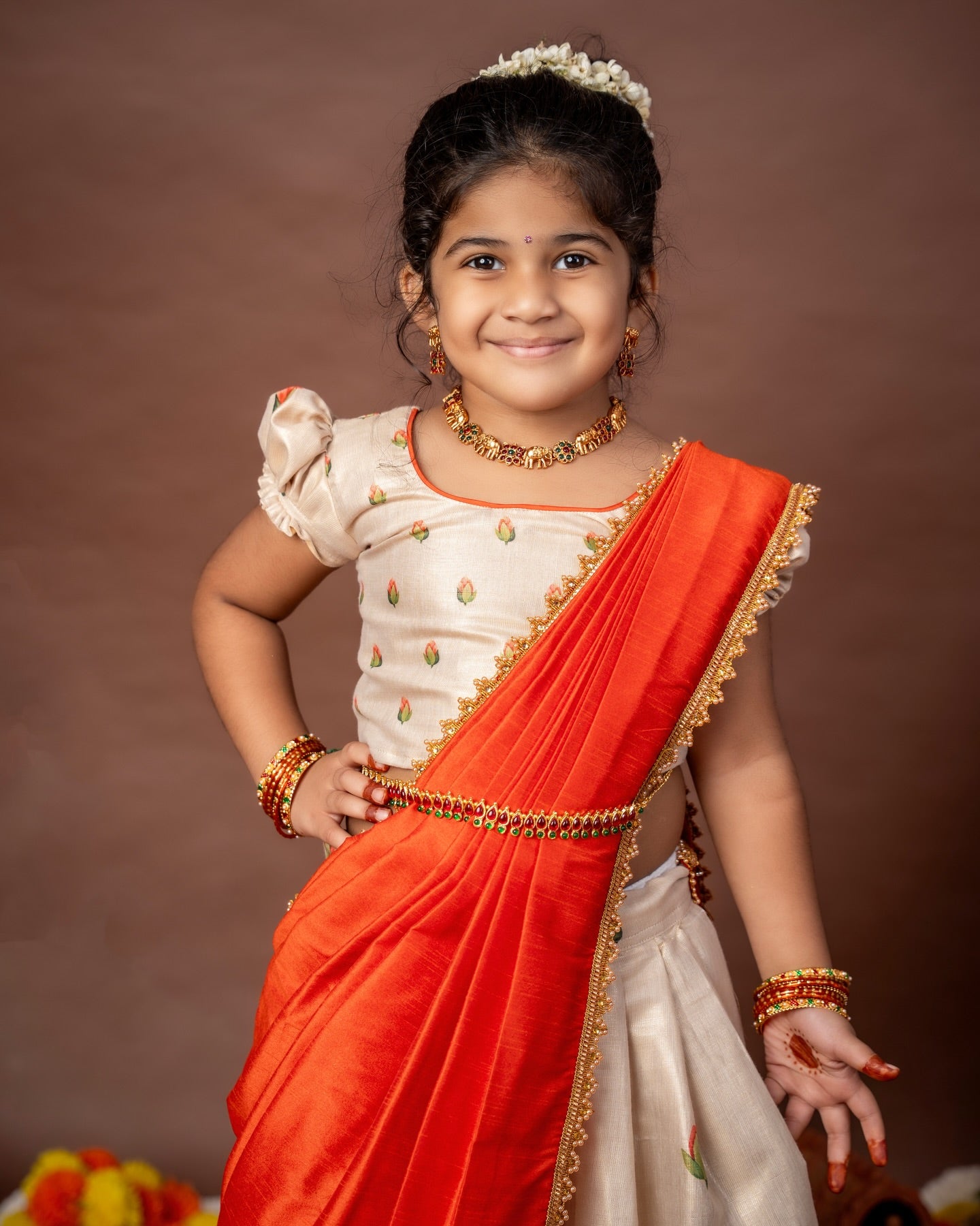 Ivory Skirt and Top floral motifs set with a contrast Orange color Thavani