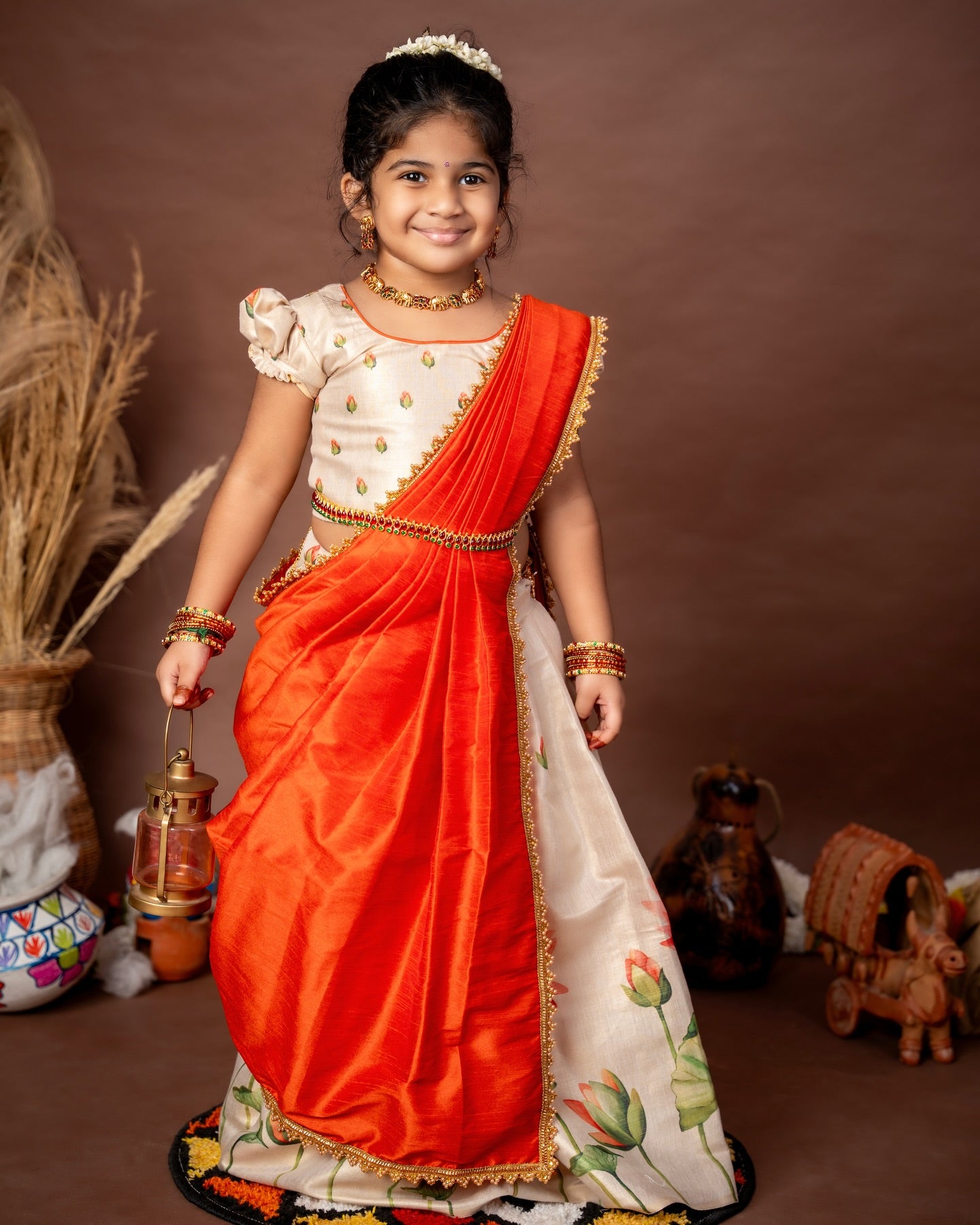 Ivory Skirt and Top floral motifs set with a contrast Orange color Thavani