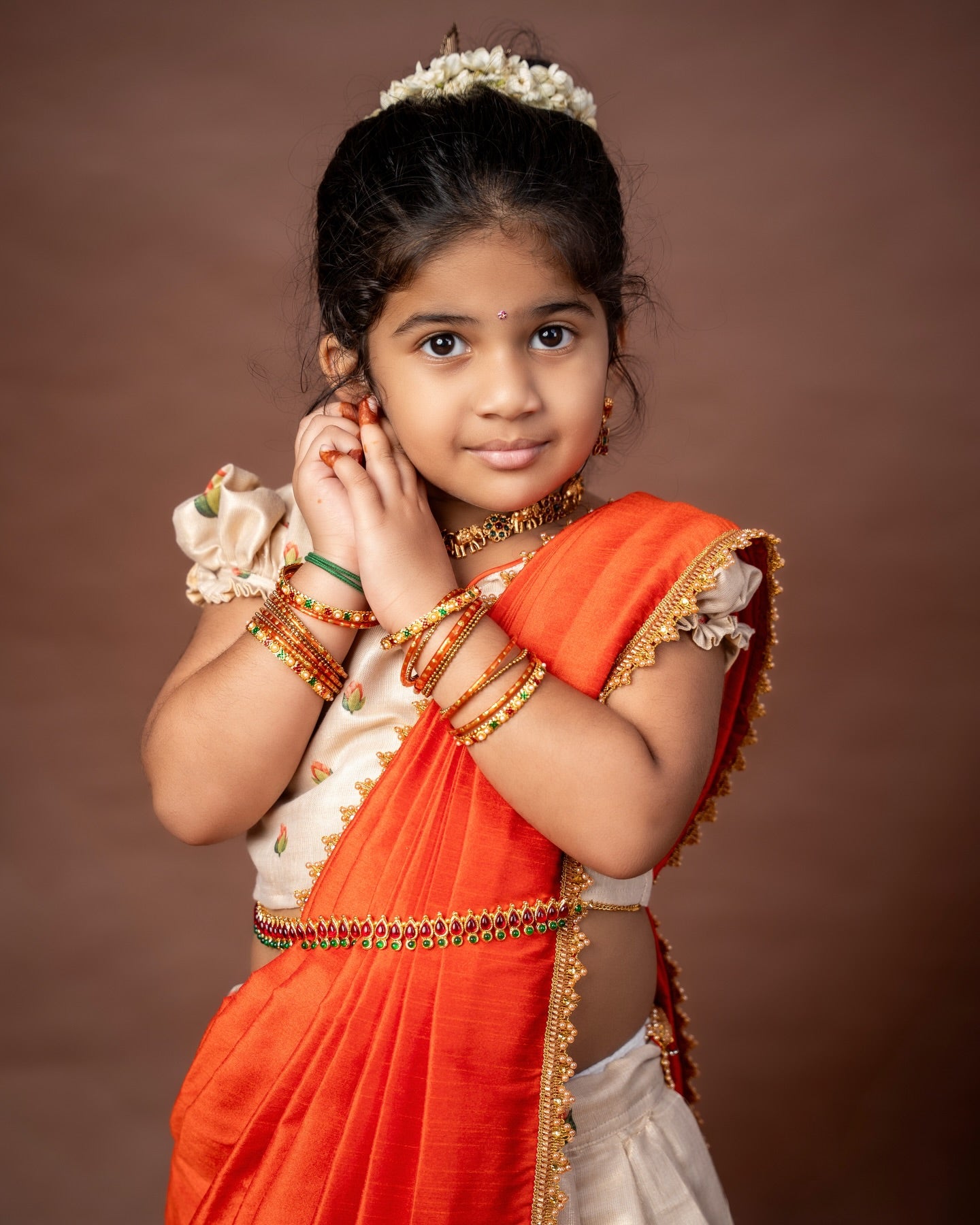 Ivory Skirt and Top floral motifs set with a contrast Orange color Thavani
