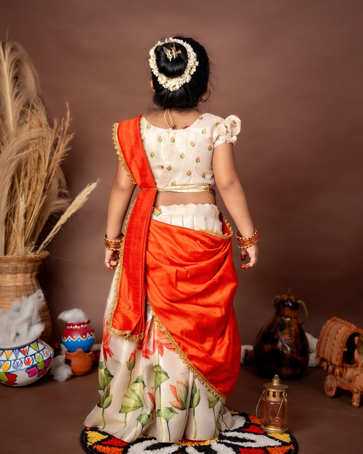 Ivory Skirt and Top floral motifs set with a contrast Orange color Thavani