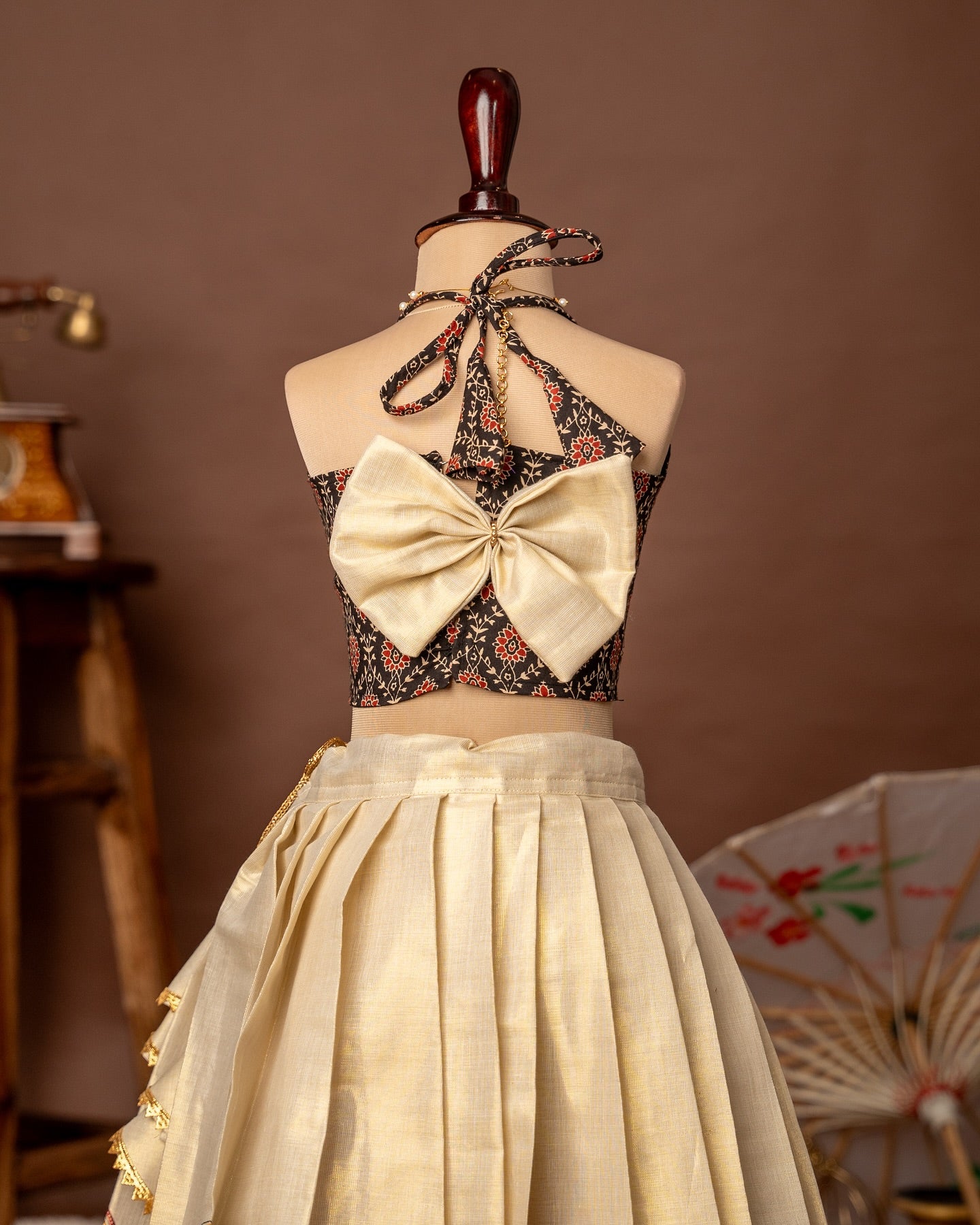 Black Ajrakh Halter Neck Top and Traditional Kathakali Motif Kasavu Skirt – Minmini Onam Collections